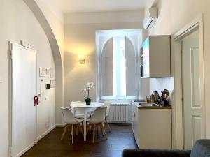 een keuken en eetkamer met een tafel en een raam bij Eccelso Suites in Rome