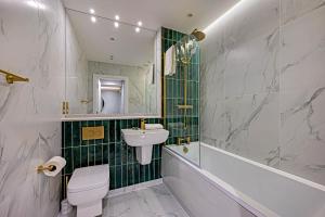 a bathroom with a sink and a toilet and a tub at Host & Stay - Catharine Quarters in Liverpool +95 photos