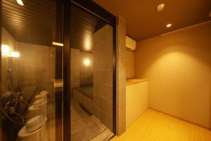 a bathroom with two toilets and a glass door at Towa Ryokan in Kyoto