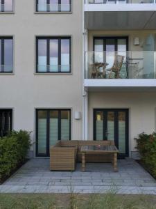 a bench sitting in front of a building at Ferienwohnung "Julie" - Haus Alando in Prora