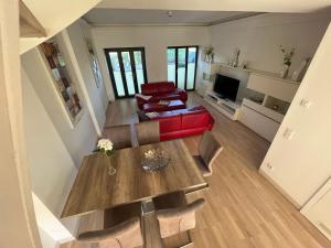 an overhead view of a living room with a table and chairs at Ferienwohnung "Julie" - Haus Alando in Prora