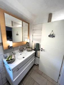 a bathroom with a sink and a mirror at Ferienwohnung Classen Eifel in Schleiden