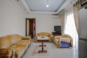 a living room with two couches and a coffee table at Sea La Vie Apartments in Ksamil