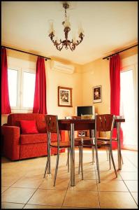 a dining room with a table and chairs and a couch at ilyda Residence apts in Skala Kallonis
