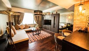 a living room with a couch and a table at Rose Garden Hotel in Yangon