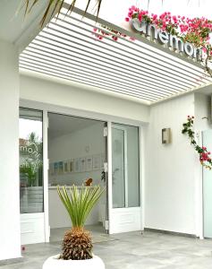 a building with a sign on the front of it at Anemoni Beach Hotel in Skiathos Town