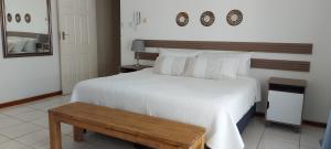 a bedroom with a large bed and a wooden table at Hi-Life Villa in Gaborone