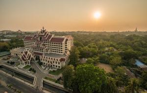 an aerial view of a building with a sunset in the background at Rose Garden Hotel in Yangon