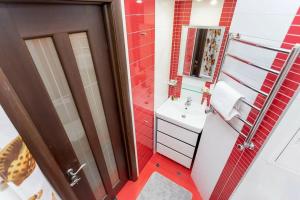 a small bathroom with a sink and a mirror at Арбат in Almaty +10 photos