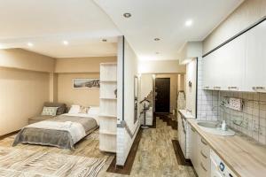 a bedroom with a bed and a sink in it at Арбат in Almaty