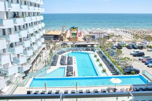 an aerial view of a hotel with a swimming pool and the ocean at Sea-esta Studio in Infinity Beach Resort in Mamaia