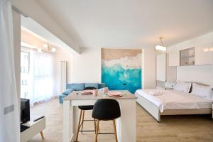 a living room with a bed and a table in a room at Sea-esta Studio in Infinity Beach Resort in Mamaia +36 photos