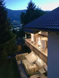 a building with a balcony with a view of a city at Restaurant Appartements Almdiele in Hart im Zillertal