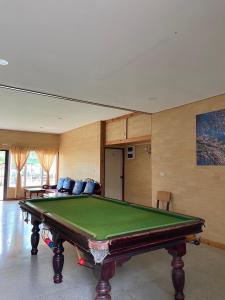 a living room with a pool table in it at Loongmun Beach in Cha Am