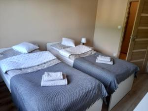 Posteľ alebo postele v izbe v ubytovaní Apartament Górski