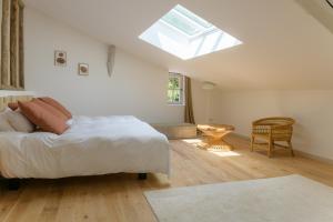 a bedroom with a bed and a skylight at Le Moulin Dumas in Grignan