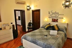 a bedroom with a bed with a laptop on it at Casa Vacanze Via Roma 148 in Syracuse