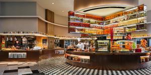 a restaurant with a bar with a chef preparing food at Grand Copthorne Waterfront Hotel Singapore in Singapore