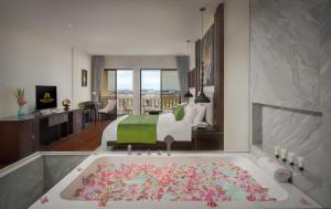 a hotel room with a bath tub with a bed at Borei Angkor Resort & Spa in Siem Reap