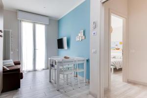 a living room with a table and a blue wall at La Corte dei Mari in Cesenatico