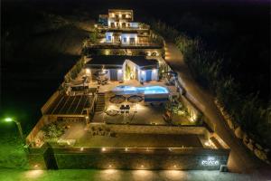 an aerial view of a mansion at night at Mnḗmē Suites & Villas in Kastrí