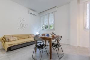 a living room with a table and a couch at Borgo Panigale Viola Apartment in Bologna
