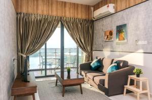 a living room with a couch and a large window at Country Garden Danga Bay @ UHA in Johor Bahru
