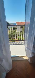 a view from a window of a porch with a fence at Apartments and Rooms Batoš in Zavala