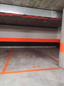 a bed in a room with an orange line on the floor at Bonito estudio con garaje in Bilbao