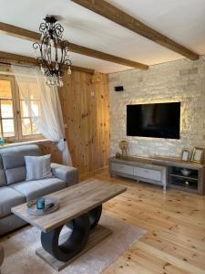 a living room with a couch and a table at Planinska kuca Grujic in Kolašin