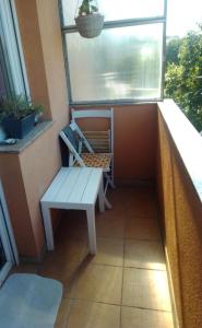 a balcony with a bench and a window at Nika in Rijeka