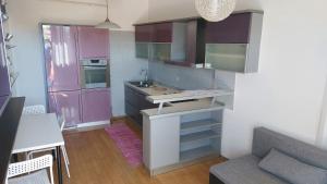 a small kitchen with purple cabinets and a sink at Nika in Rijeka