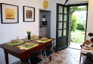 a dining room with a wooden table and chairs at AMAZING LANGHE AND MONFERRATO | House with garden in Calamandrana