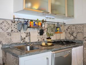 a kitchen with a sink and a stove at AMAZING LANGHE AND MONFERRATO | House with garden in Calamandrana