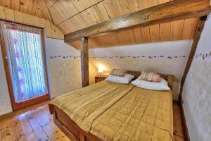a bedroom with a large bed with a wooden ceiling at Betlehem Resort in Zgornje Gorje