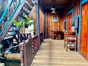 a wooden walkway in a house with a staircase at Sothea Angkor Homestay in Phumi Ta Phul