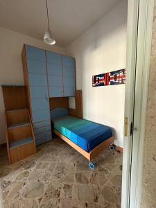 a small bedroom with a bed and a cabinet at Appartamento Sea La Vie in Custonaci