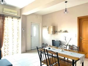 a kitchen and dining room with a table and chairs at Maria Apartments in Paleros