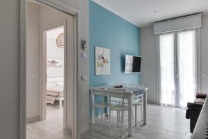 une salle à manger avec une table et un mur bleu dans l'établissement La Corte dei Mari, à Cesenatico