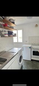 a kitchen with a sink and a washing machine at Appartamento con ampio Terrazzo in Rome