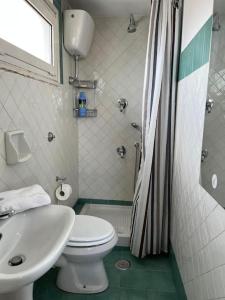 a bathroom with a white toilet and a sink at Appartamento con ampio Terrazzo in Rome