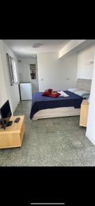 a bedroom with a bed with a blue comforter at Appartamento con ampio Terrazzo in Rome