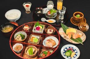 a table topped with plates of food on a table at Sora Niwa Terrace Kyoto Bettei in Kyoto