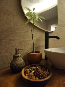 a bathroom counter with a sink and a potted plant at Ozgur Bey Spa Hotel in Alanya
