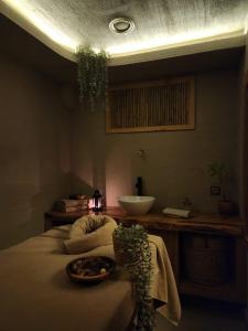 a bathroom with a sink and a bed with a bowl on it at Ozgur Bey Spa Hotel in Alanya