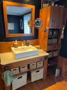 a bathroom with a sink and a mirror and baskets at Cannes charming villa private pool garden 1,7 kms from sea and sand beach in Le Cannet