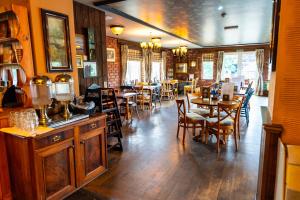 a dining room with tables and chairs in a restaurant at The Lindisfarne Inn - The Inn Collection Group in Beal