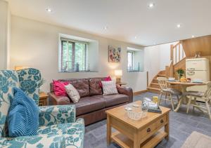 a living room with a couch and a table at The Hayloft Dunmere in Bodmin