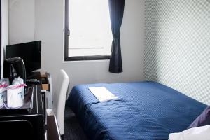 Postel nebo postele na pokoji v ubytování Hotel Livemax BUDGET Kanazawa-Idaimae