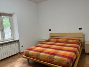 a bedroom with a bed and a window at HAPPY HOME in Orte +6 photos